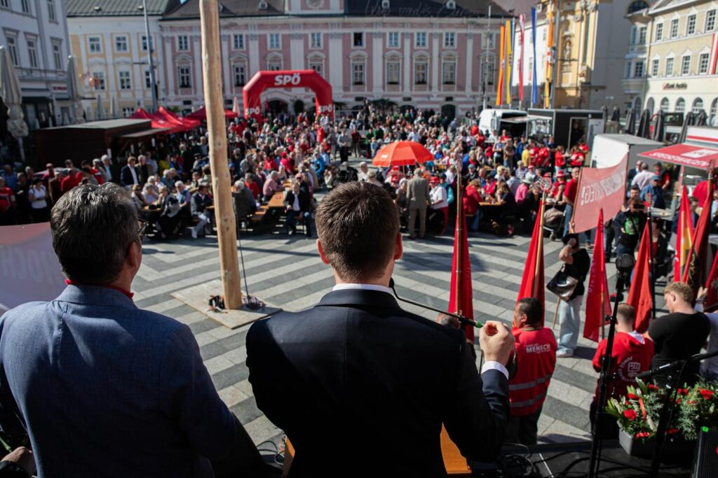 Sven Hergovich hält eine Rede zum 1. Mai in St. Pölten und spricht vor einer Menschenmenge, die sich versammelt hat, um den Tag der Arbeit zu feiern.